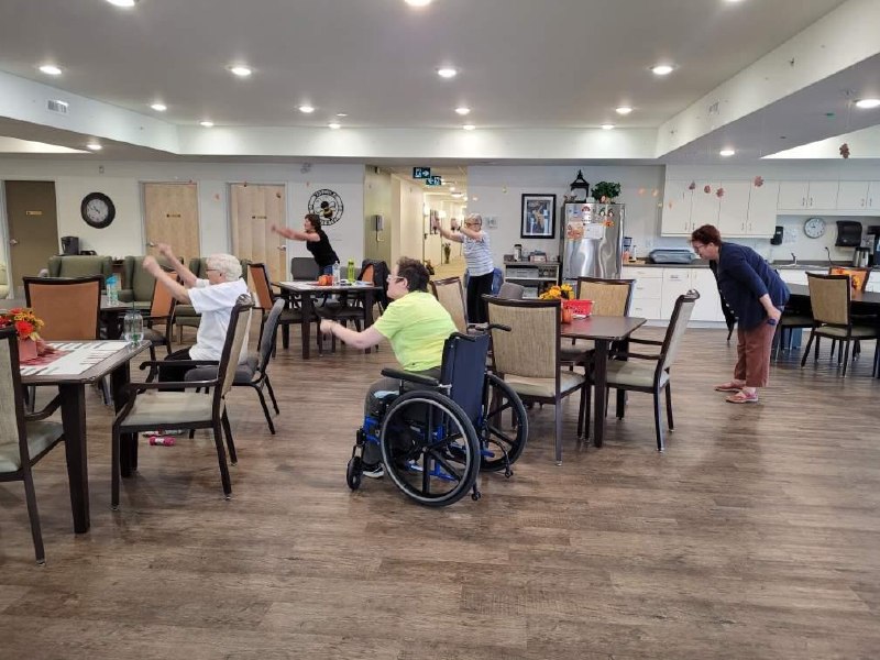 Seniors following along with Better5 class, including wheelchair user